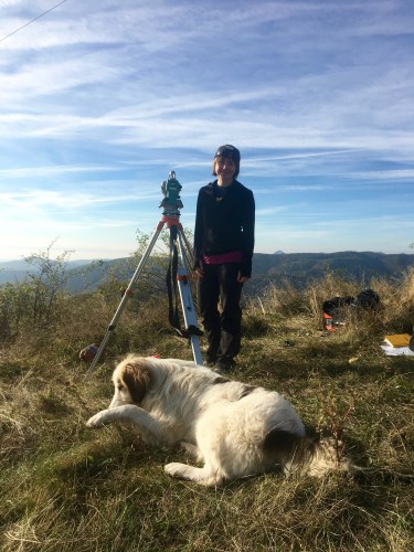 He lingered, just inches away from the total station legs, wagging his tail...